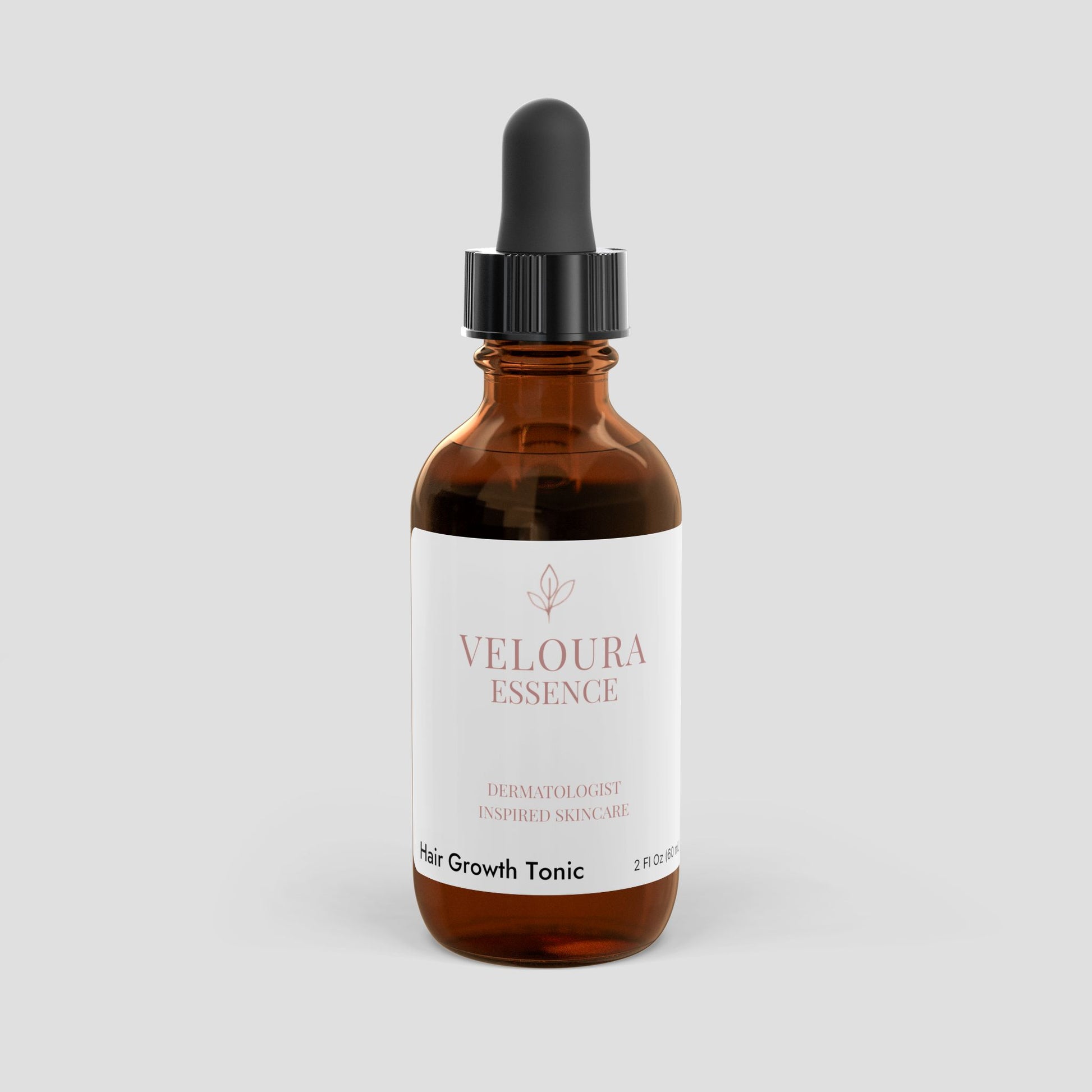 Bottle of Veloura Essence Hair Growth Tonic on a light gray background